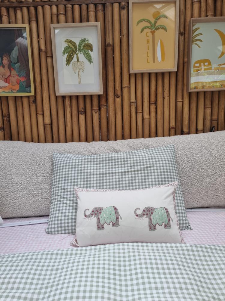 Close-up of bouclé bedhead cushion texture with decorative pillows