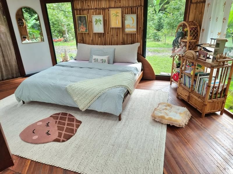 Bouclé bedhead cushion in tropical bedroom with bamboo wall