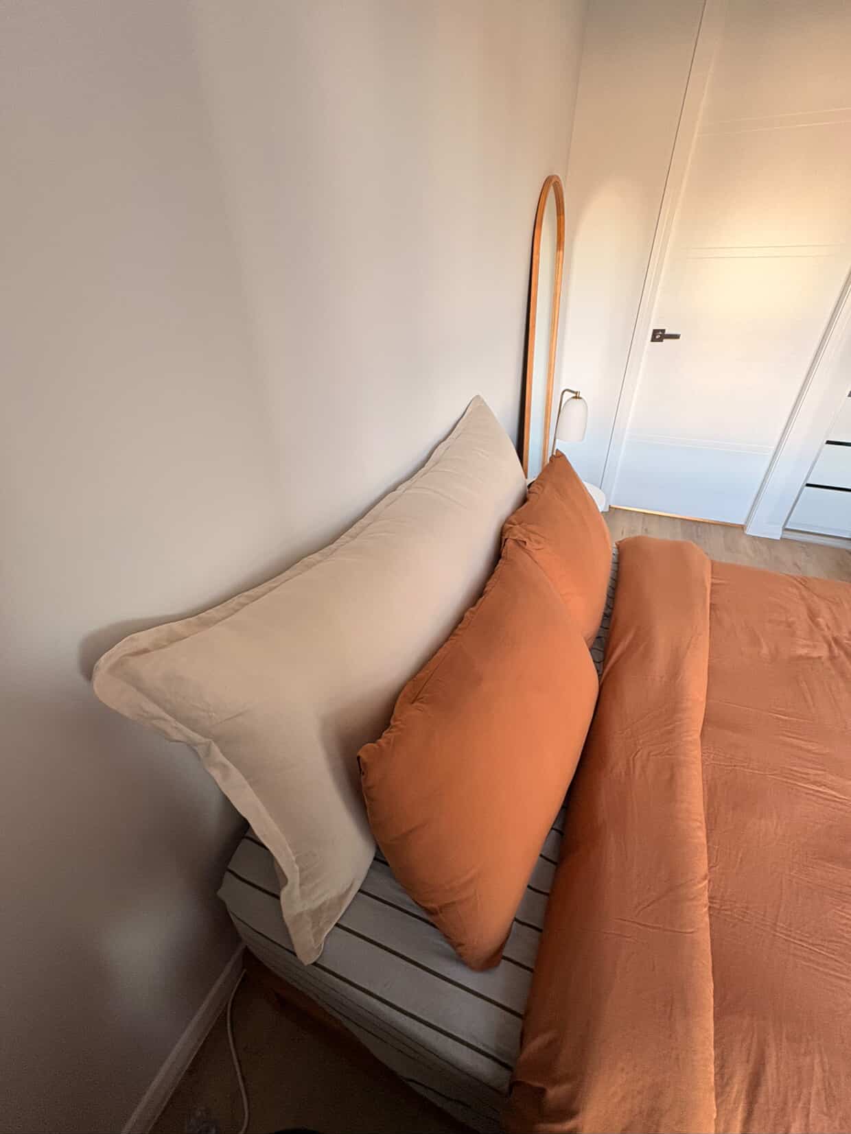 Stone linen bedhead cushion corner view with modern bedroom styling