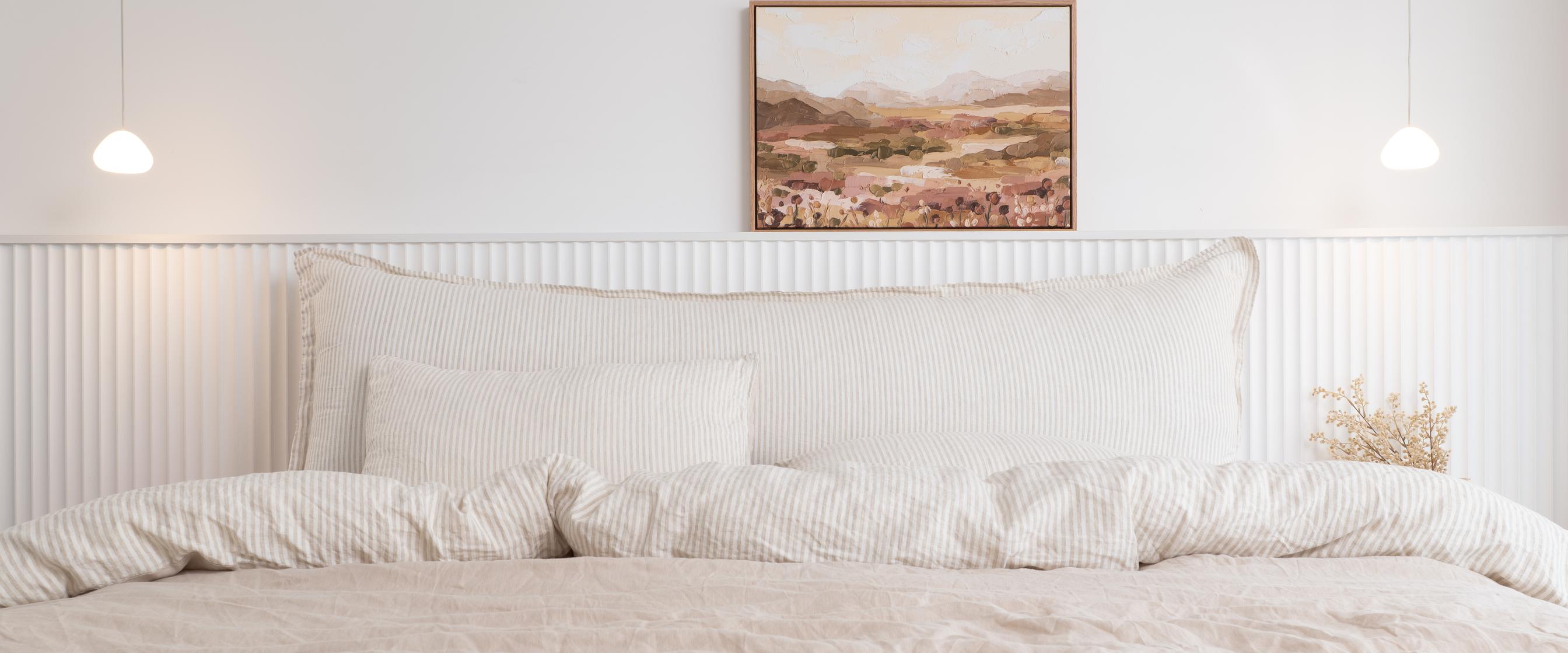 Oat Latte Arlem Bedhead Cushion spanning a bed, photographed front on