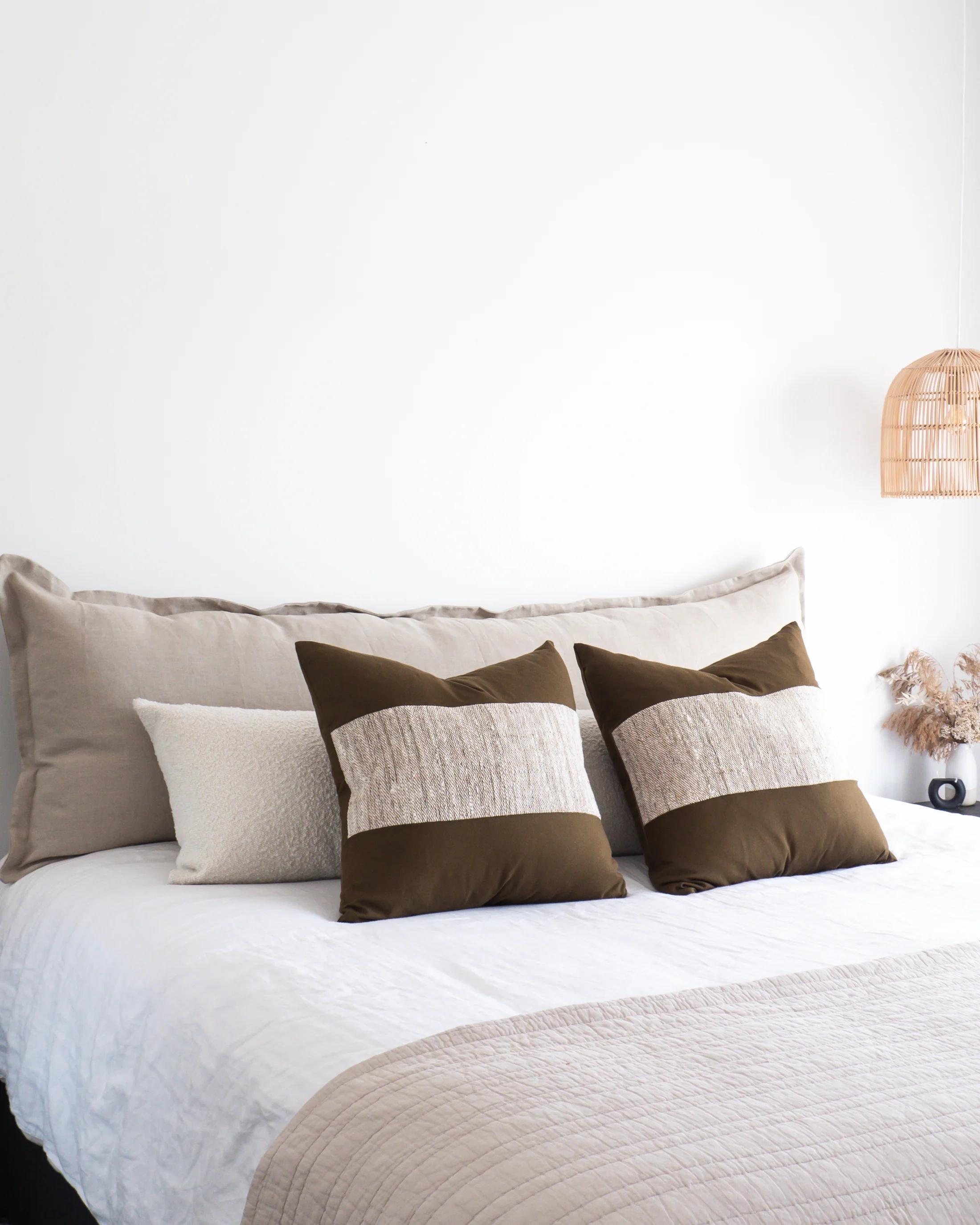 Meadow linen Arlem Bedhead Cushion styled with sleeping pillows in front