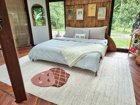 Bouclé bedhead cushion styled in tropical bedroom