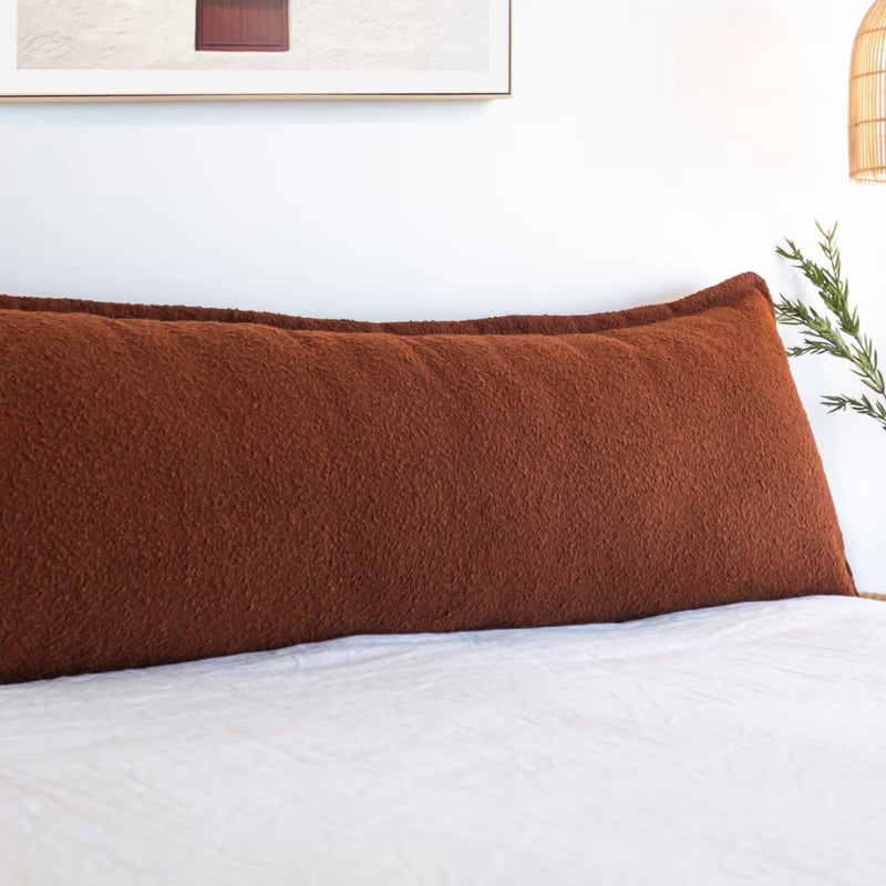 Linen bedhead cushion with French seam against white wall